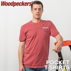 A man wearing the crimson pocket t-shirt with the Woodpeckers logo embroidered above the pocket while leaning against a ladder.