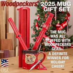 The 12 ounce Woodpeckers mug sitting on a workbench with tools in it.
