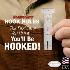 Woodpeckers Hook Rule being pulled out of a front apron pocket.