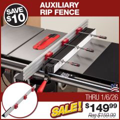 The Auxiliary Rip Fence installed on a Sawstop rip fence with track clamps in the standard, high fence orientation and the material support installed on the infeed.