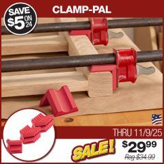 Close-up photograph showing two pipe clamps being supported by Clamp-Pals on a white oak leg assembly glue-up.
