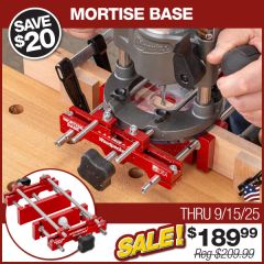 The Mortise Base straddling a thin, 3/4" table leg while being used to rout a precise 1/4" wide mortise. Scraps of wood are clamped to the workpiece to limit the length of the mortise. 