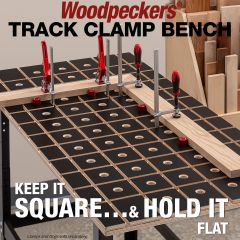 Mitered boards aligned to bench dogs and clamped with track clamps