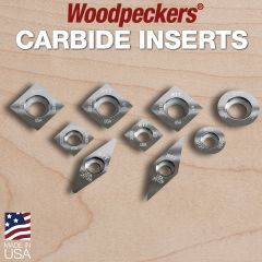 All carbide inserts sitting on a piece of maple. 	