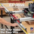 Image of controls on EZ-Drive System. Hands on cranks feeding router carriage over natural edge slab.