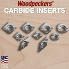 All carbide inserts sitting on a piece of maple. 	